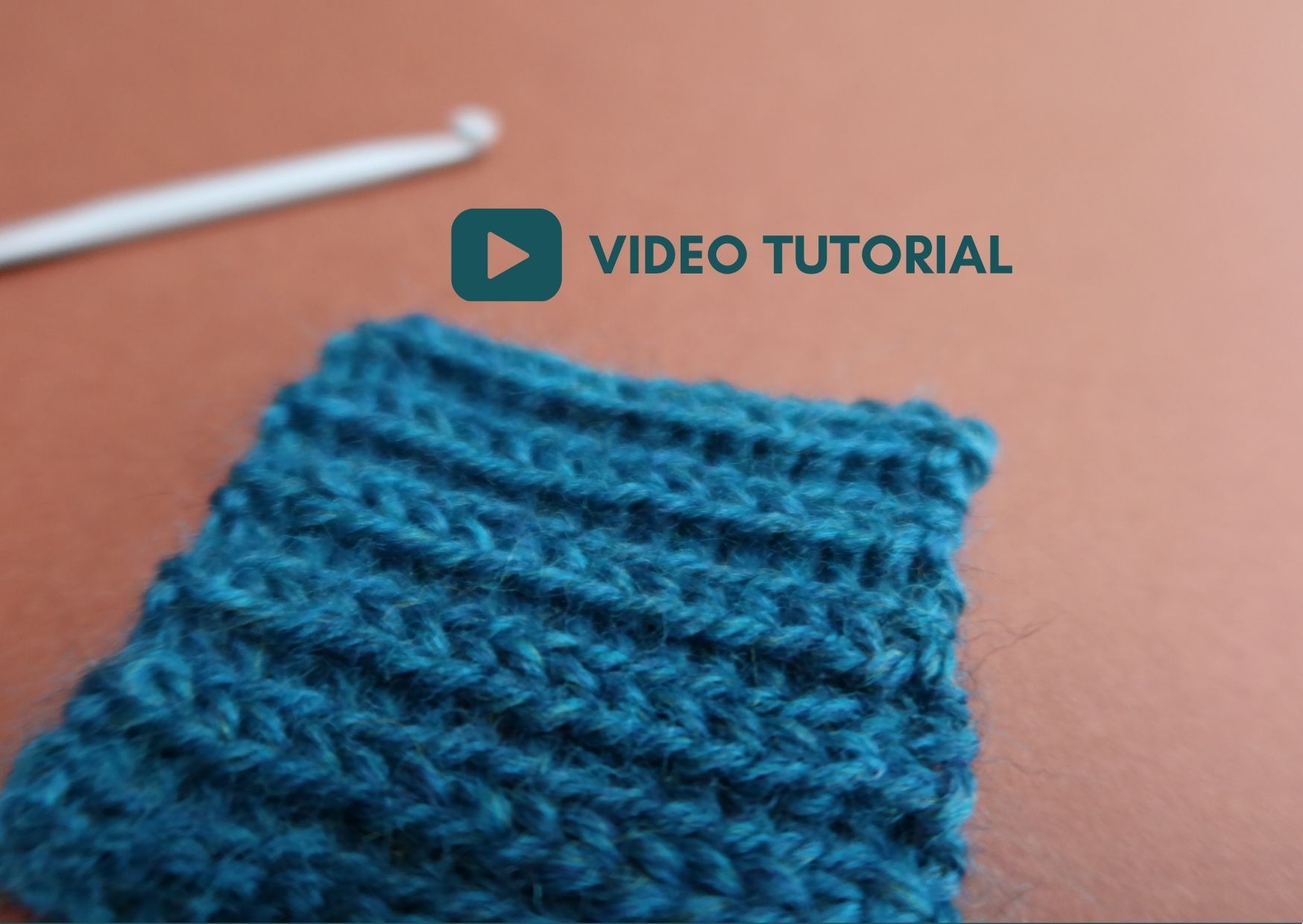 Close up of teal wool swatch made up of double slip stitches.