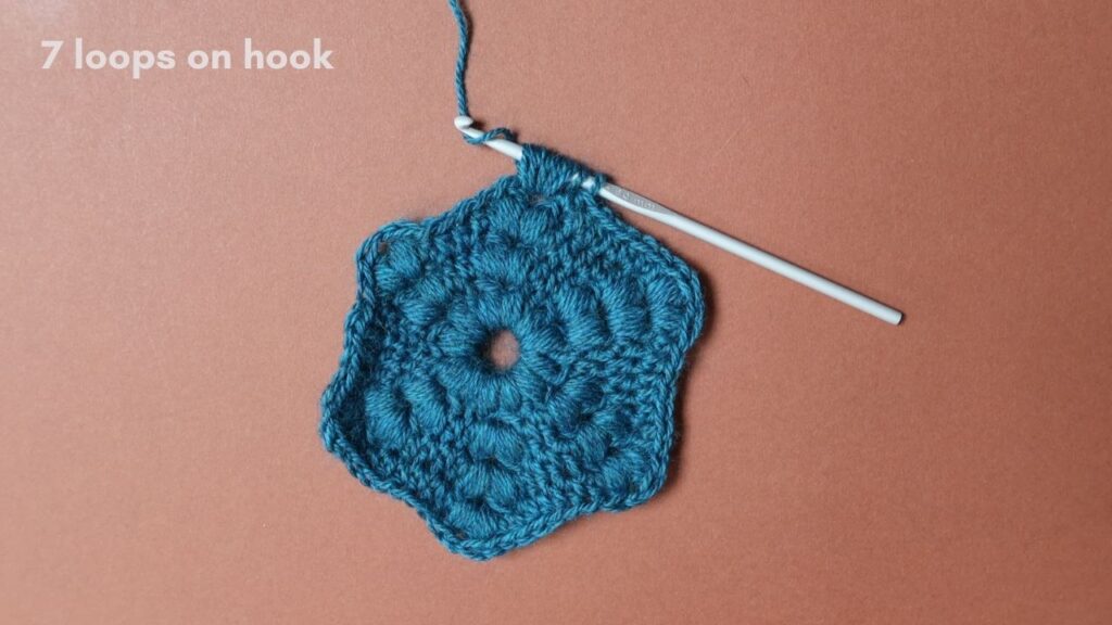 Puff Stitch crochet tutorial step 6 with a teal hexagon motif.