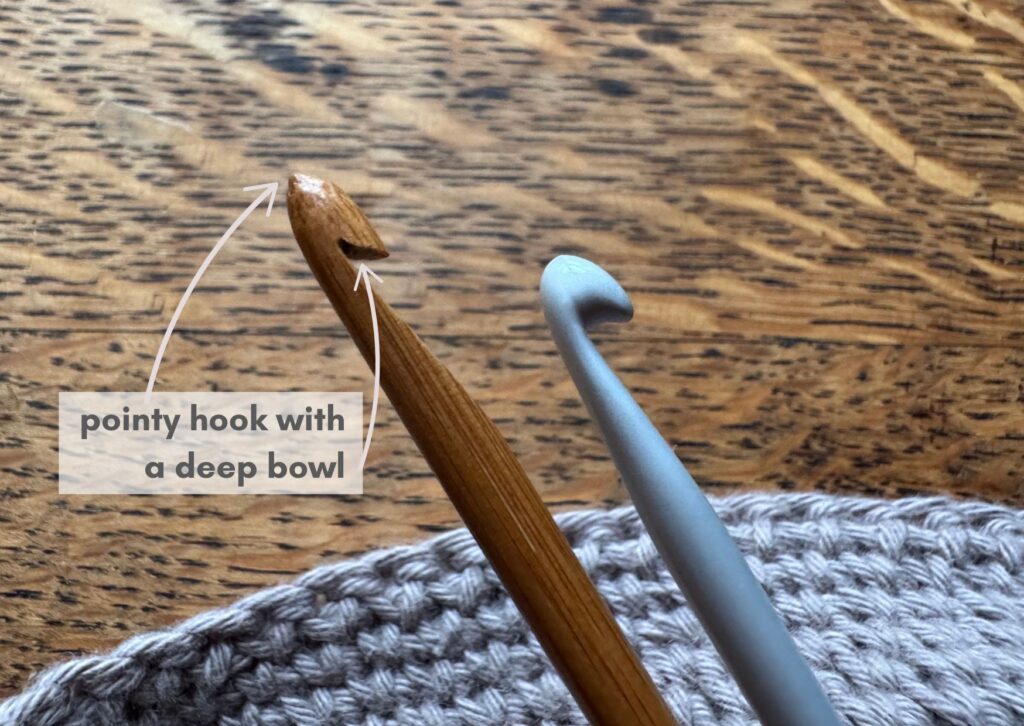 Wooden scoop filled with white granular salt on a marble surface