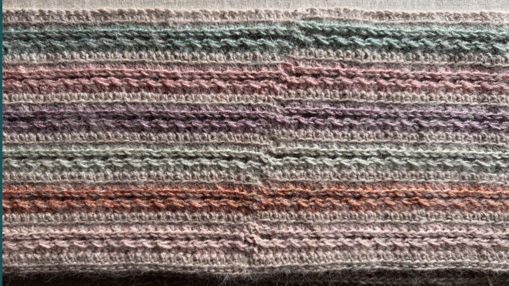 Crocheted cowl with third loop starting half treble sticthes to start rounds.