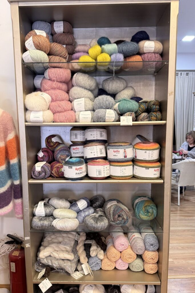 Shelves of yarn in muted colours.