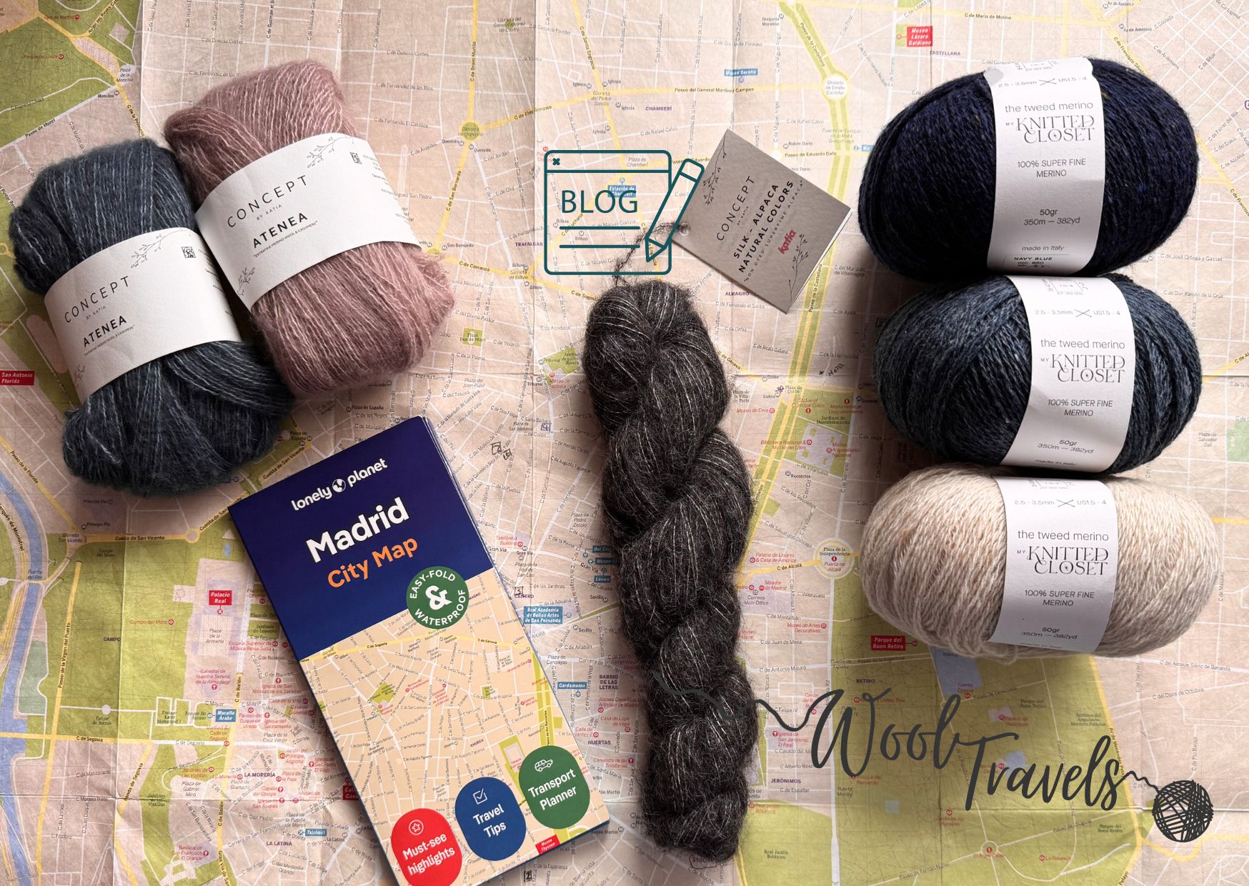 Map of Madrid opened out with various balls and skeins of yarn spread out on it.