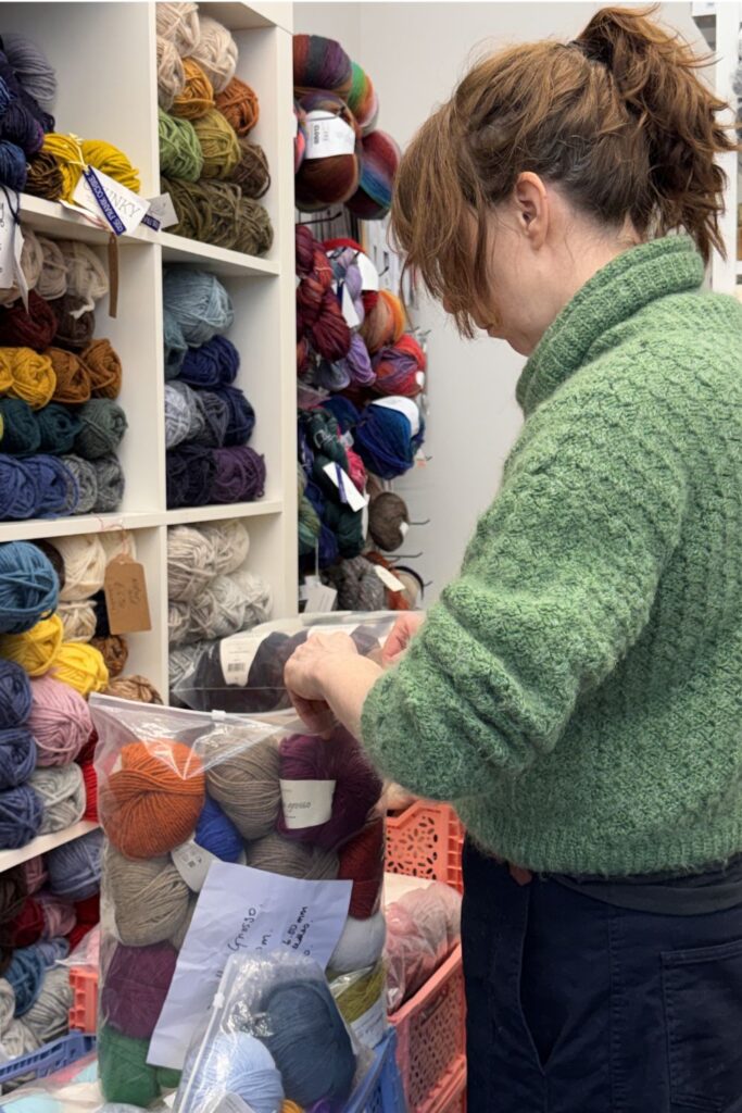 My friend rummaging through bags of yarn at Be Inspired Fribres.