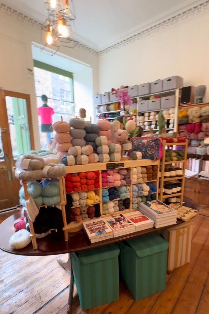 Centre island of Fibre Yard shop full of yarn and books. 