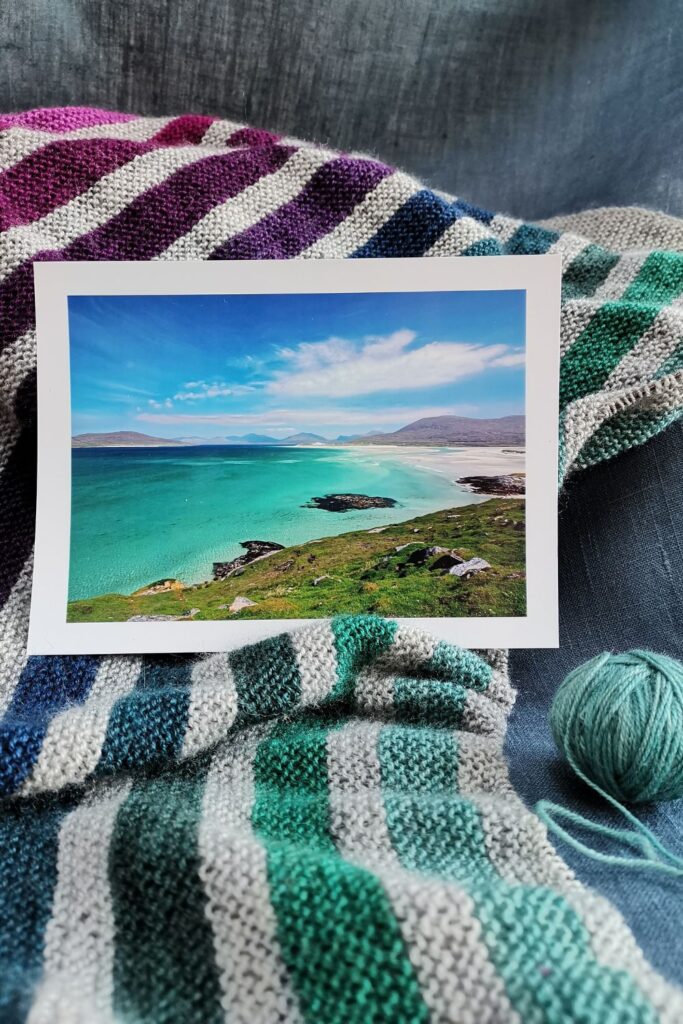 Striped knitted blanket pattern in light grey with earthy Scottish coloured stripes.