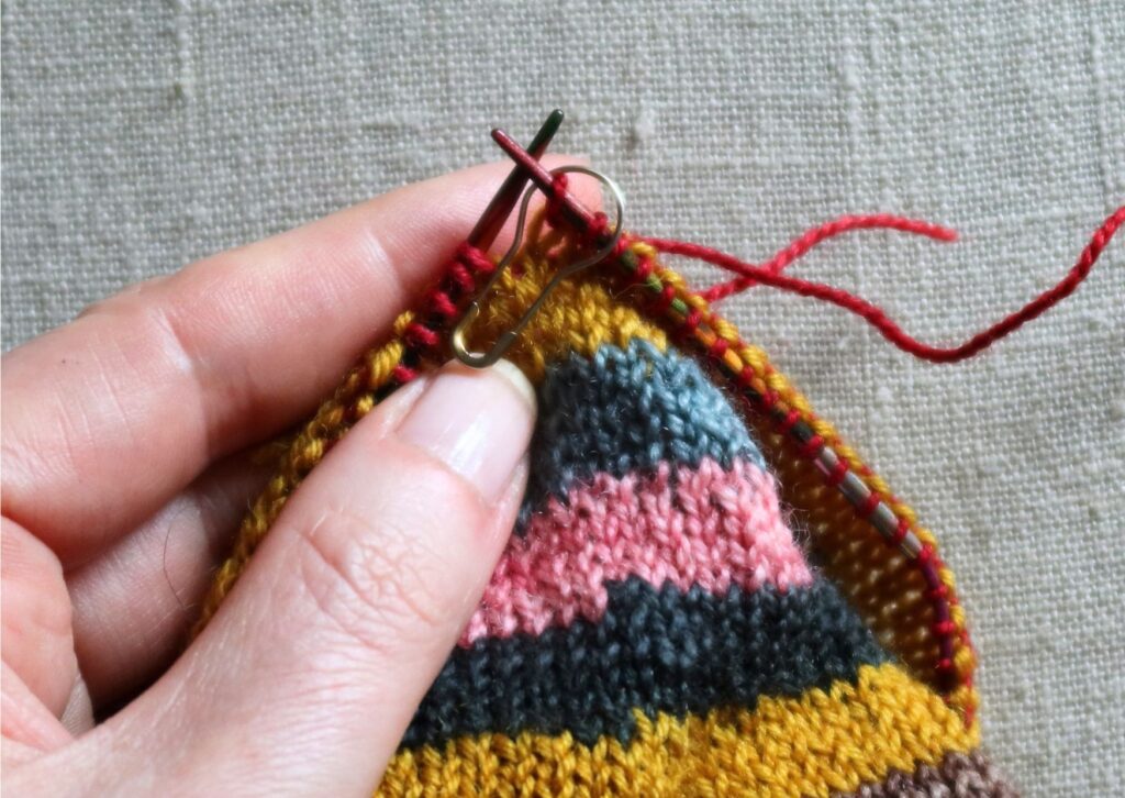 Close up of stripy trainer socks being knitted.