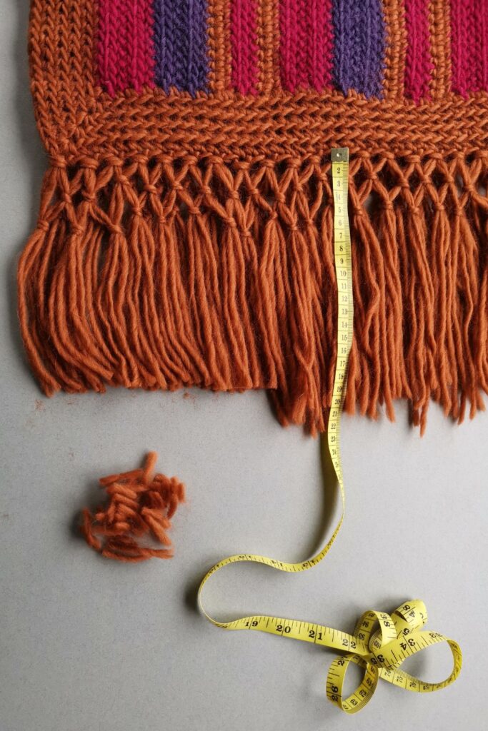 Retro striped crochet blanket with knotted fringe.
